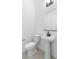 Modern powder room with pedestal sink and toilet at 37767 W Padilla St, Maricopa, AZ 85138