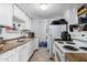 Galley-style kitchen with white cabinets and appliances at 4625 E Southgate Ave, Phoenix, AZ 85040