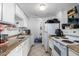 Galley-style kitchen with white cabinets and appliances at 4625 E Southgate Ave, Phoenix, AZ 85040