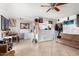 Living room with brown couch, ceiling fan and access to kitchen at 4625 E Southgate Ave, Phoenix, AZ 85040