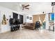 Living room with brown couch, large TV, and sliding door at 4625 E Southgate Ave, Phoenix, AZ 85040