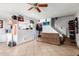 Living room with brown couch, ceiling fan and access to kitchen at 4625 E Southgate Ave, Phoenix, AZ 85040