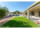 Landscaped backyard with a pool and covered patio at 5827 W Charter Oak Rd, Glendale, AZ 85304