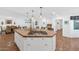 Large kitchen island with seating, gas cooktop, and white cabinetry at 6319 E Mariposa St, Scottsdale, AZ 85251