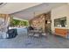 Outdoor patio with seating, a stone wall, and a view of the pool at 6319 E Mariposa St, Scottsdale, AZ 85251