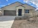 New construction home with two-car garage and desert landscaping at 653 W Freedom St, Florence, AZ 85132