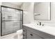 Bathroom with gray vanity and a walk-in shower at 7834 W Forest Grove Ave, Phoenix, AZ 85043