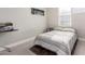 Bedroom with striped bedding and large window at 7834 W Forest Grove Ave, Phoenix, AZ 85043