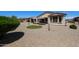 Charming backyard includes desert landscaping, a circular artificial lawn, and a covered patio area for relaxation at 17915 W Silver Fox Way, Goodyear, AZ 85338