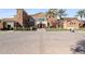 Elegant clubhouse featuring palm trees, manicured landscaping, and an inviting entrance, perfect for community gatherings at 17915 W Silver Fox Way, Goodyear, AZ 85338