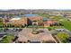 Stunning aerial view of the community clubhouse with a grand entrance, ample parking, and scenic water views at 17915 W Silver Fox Way, Goodyear, AZ 85338