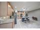 Spacious kitchen featuring a granite-topped island, light wood cabinetry, and stainless steel appliances at 17915 W Silver Fox Way, Goodyear, AZ 85338