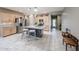 Island kitchen with granite counters, stainless appliances, and light wood cabinets, plus barstool seating at 17915 W Silver Fox Way, Goodyear, AZ 85338