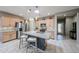 Kitchen showcasing a large island with seating, stainless steel appliances, and a stylish tiled backsplash at 17915 W Silver Fox Way, Goodyear, AZ 85338
