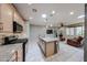 Well-equipped kitchen with granite countertops, light wood cabinets, and modern appliances, adjacent to the living area at 17915 W Silver Fox Way, Goodyear, AZ 85338