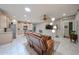 Spacious living area with access to the kitchen, stylish lighting, and comfortable seating on tile floors at 17915 W Silver Fox Way, Goodyear, AZ 85338