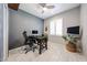 Bright office features a desk, ceiling fan and a large window for ample light at 17915 W Silver Fox Way, Goodyear, AZ 85338