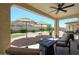 Covered patio showcases comfortable seating, a fire pit and views of the landscaped backyard at 17915 W Silver Fox Way, Goodyear, AZ 85338
