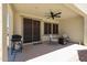 Cozy covered patio with a ceiling fan, seating and a BBQ grill for outdoor enjoyment at 17915 W Silver Fox Way, Goodyear, AZ 85338