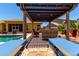 Relaxing backyard featuring lounge chairs under a pergola, overlooking the refreshing pool at 18174 W Wind Song Ave, Goodyear, AZ 85338