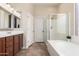 Bright bathroom with a separate shower and soaking tub with natural light at 18174 W Wind Song Ave, Goodyear, AZ 85338