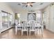 Bright dining room with neutral walls, tile floors, large windows and a stylish dining set at 18174 W Wind Song Ave, Goodyear, AZ 85338