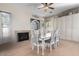 Elegant dining room showcasing neutral walls, tile floors, a fireplace, and a large cabinet at 18174 W Wind Song Ave, Goodyear, AZ 85338