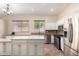 Bright, open kitchen with stainless steel appliances, granite countertops, and a center island, perfect for cooking and entertaining at 18174 W Wind Song Ave, Goodyear, AZ 85338