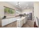 Lovely kitchen featuring granite counters, stainless appliances, ample cabinet space, and a breakfast bar overlooking the dining area at 18174 W Wind Song Ave, Goodyear, AZ 85338