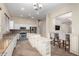 Bright kitchen featuring granite countertops, white cabinetry, stainless steel appliances, and a convenient breakfast bar at 18174 W Wind Song Ave, Goodyear, AZ 85338