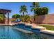 Gorgeous backyard pool with a tanning ledge and comfortable lounge chairs for soaking up the sun at 18174 W Wind Song Ave, Goodyear, AZ 85338