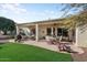 Covered patio with outdoor seating and artificial turf at 20103 N 265Th Ave, Buckeye, AZ 85396