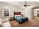 Bright bedroom with ceiling fan and wooden headboard at 20103 N 265Th Ave, Buckeye, AZ 85396