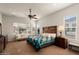 Main bedroom with ceiling fan and large windows at 20103 N 265Th Ave, Buckeye, AZ 85396