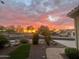 Sunset view of front yard with desert landscaping and a paved walkway at 20103 N 265Th Ave, Buckeye, AZ 85396