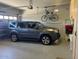 Spacious garage with overhead storage and room for a vehicle and bicycle at 20103 N 265Th Ave, Buckeye, AZ 85396