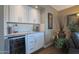 Wet bar with granite countertop, wine cooler, and white shaker cabinets at 2237 E Nicolet Ave, Phoenix, AZ 85020