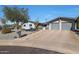 Single story home with gray exterior, two car garage, and desert landscaping at 2237 E Nicolet Ave, Phoenix, AZ 85020