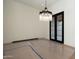 Large dining area featuring modern chandelier lighting, a neutral color palette, and elegant wood flooring at 23002 N Country Club Trl Trl, Scottsdale, AZ 85255