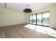 Open living space featuring hardwood floors, modern lighting, and large windows with backyard views at 23002 N Country Club Trl Trl, Scottsdale, AZ 85255