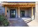 Covered patio with modern double doors leading inside at 23002 N Country Club Trl Trl, Scottsdale, AZ 85255