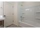 Clean bathroom with a shower/tub combo and built-in shelving at 24144 W Gibson Ln, Buckeye, AZ 85326