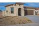 New construction home with attractive curb appeal and two-car garage at 24144 W Gibson Ln, Buckeye, AZ 85326