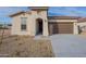 New construction home with attractive curb appeal and two-car garage at 24144 W Gibson Ln, Buckeye, AZ 85326