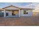 Rear view of house with covered patio and small yard at 24144 W Gibson Ln, Buckeye, AZ 85326