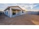 Rear view of house with covered patio and small yard at 24144 W Gibson Ln, Buckeye, AZ 85326