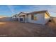 Rear view of house with covered patio and small yard at 24144 W Gibson Ln, Buckeye, AZ 85326