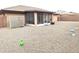 Gravel backyard with screened patio and privacy wall at 7829 E Naranja Ave, Mesa, AZ 85209