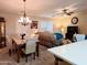 Bright dining area with seating for six and a chandelier, open to the kitchen and living room at 7829 E Naranja Ave, Mesa, AZ 85209