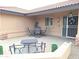 Cozy patio area with seating for four, located just outside the front entrance of the home at 7829 E Naranja Ave, Mesa, AZ 85209